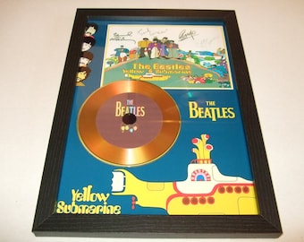 May include: A framed gold disc featuring the Beatles' Yellow Submarine album cover. The disc is signed by all four members of the band.