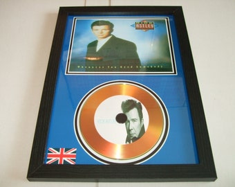 May include: A framed gold disc award featuring a picture of Rick Astley and the album cover for "Whenever You Need Somebody".