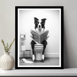 May include: A black and white photograph of a dog sitting on a toilet and reading a newspaper.