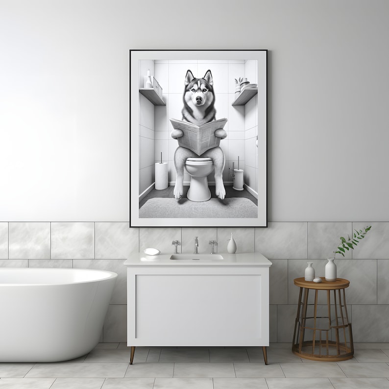 May include: Black and white photo of a husky dog sitting on a toilet and reading a newspaper in a bathroom.