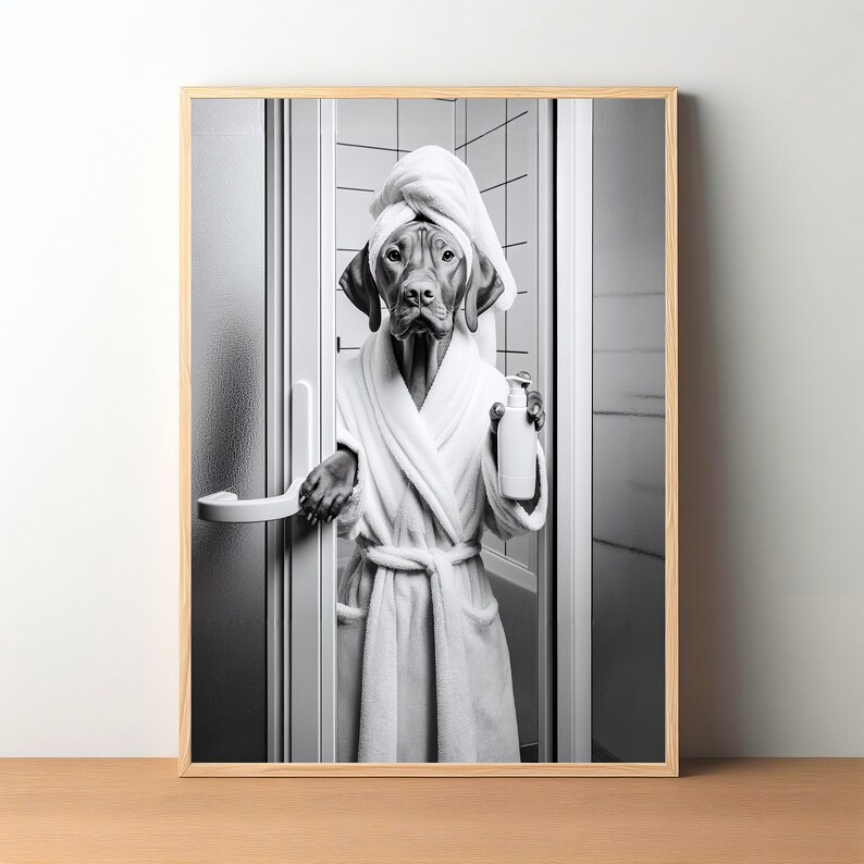 May include: A black and white photo of a dog wearing a white bathrobe and a towel on its head. The dog is holding a bottle of shampoo in its paw and is standing in a bathroom.