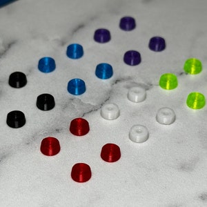 May include: Assortment of colorful plastic push buttons in various colors including black, white, red, blue, green, purple and yellow.