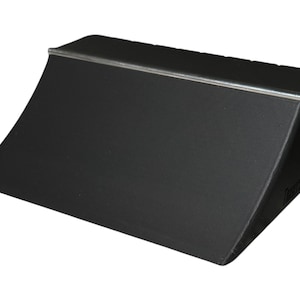 May include: A black skateboard ramp with a curved surface and a silver metal edge. The ramp is designed for skateboarding tricks and features a smooth, angled surface for launching and landing.