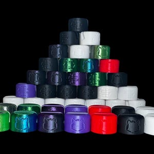 May include: A collection of colorful, 3D printed caps with a wolf head design. The caps are arranged in a pyramid shape and are made in a variety of colors, including black, white, green, red, purple, and blue.