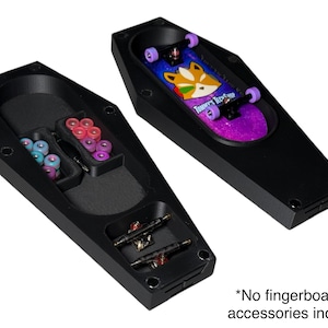 May include: Black coffin-shaped storage case with a purple and pink fingerboard inside. The case has a compartment for storing wheels and other accessories. *No fingerboards or accessories included*
