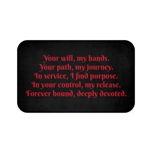 以下が含まれることがあります： 白いテキストが書かれた黒いお風呂マット。テキストは「Your will, my hands. Your path, my journey. In service, I find purpose. In your control, my release. Forever bound, deeply devoted.」です。