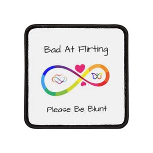 May include: White square patch with black border. The text "Bad At Flirting" is at the top. A rainbow infinity symbol with a heart and butterfly inside is in the middle. The text "Please Be Blunt" is at the bottom.