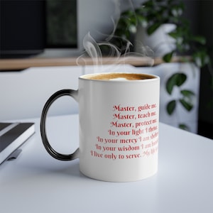 May include: A white ceramic coffee mug with a black handle. The mug has a red inscription that reads: "Master, guide me. Master, teach me. Master, protect me. In your light I thrive. In your mercy I am sheltered. In your wisdom I am humbled. I live only to serve. My life is..."