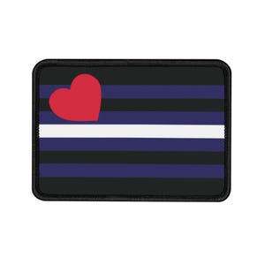 May include: A black patch with a white stripe and multiple blue stripes. A red heart is in the top left corner.