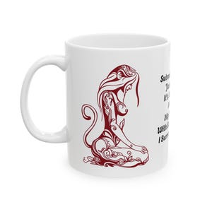 May include: White ceramic mug featuring a red illustration of a woman with a floral design. The text on the mug reads "Submission is just a word. It's how you make it mean something. My body is my choice. With every breath I surrender."