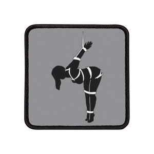 May include: A black and white silhouette of a person tied up with rope, against a gray background. The person is hanging from the ceiling and is bent over at the waist.