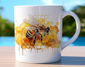 May include: White ceramic mug featuring a watercolour illustration of a bee on a honeycomb. The bee is yellow and black with brown stripes. The honeycomb is yellow and brown with a watercolour effect. The background is white with a few yellow and brown watercolour splatters.