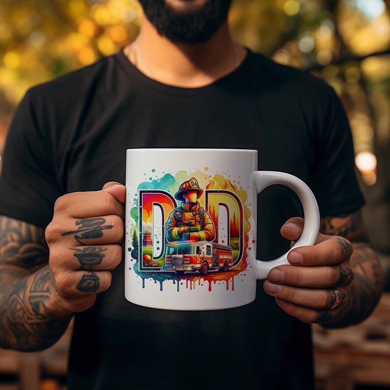 May include: White ceramic mug with a colorful watercolor design featuring a firefighter standing in front of a fire truck. The text "DAD" is incorporated into the design.