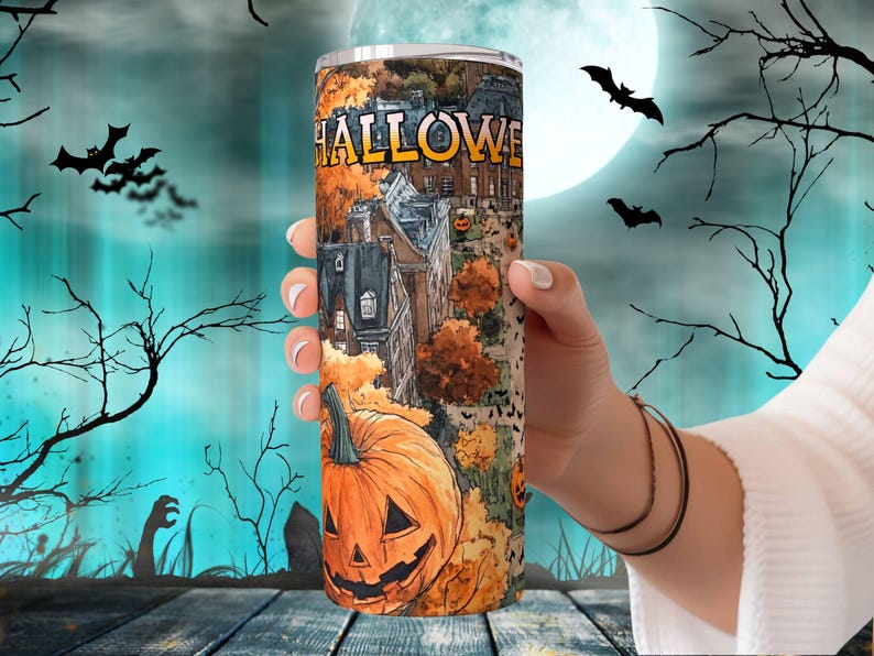 May include: A stainless steel tumbler with a Halloween themed design. The design features a spooky cityscape with a pumpkin, bats, and the word "HALLOWEEN".