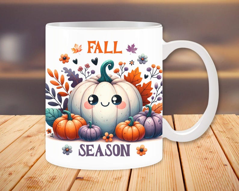 May include: White ceramic mug featuring a cartoon illustration of a smiling white pumpkin surrounded by orange, purple, and green pumpkins, leaves, and flowers. The words "FALL SEASON" are printed on the mug.