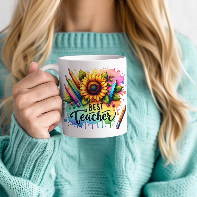 May include: White ceramic mug with a colourful watercolour design featuring a sunflower, pencils, and the text "Best Teacher".