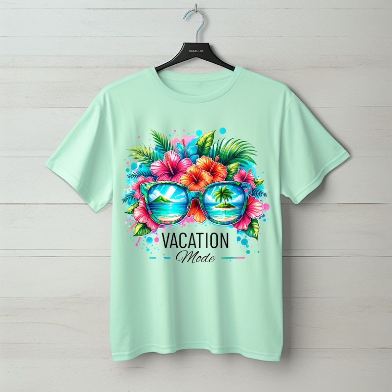 May include: A light green t-shirt with a colorful graphic of sunglasses with tropical flowers and palm trees. The sunglasses reflect a beach scene. The text "VACATION Mode" is printed below the sunglasses.