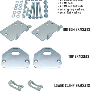 Puede incluir: Un conjunto de soportes met&aacute;licos y herrajes para montar un portaequipajes de techo de coche. El conjunto incluye soportes superiores e inferiores, soportes de abrazadera inferiores, tornillos, tuercas y arandelas. La herrajer&iacute;a es de color plateado.