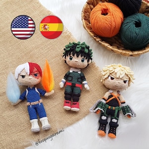 May include: Crocheted figures of anime characters, including one with red and white hair, a blue and white outfit, and a flame and ice accessory. Other figures have green and blonde hair, with detailed outfits. Yarn balls in a basket are in the background.