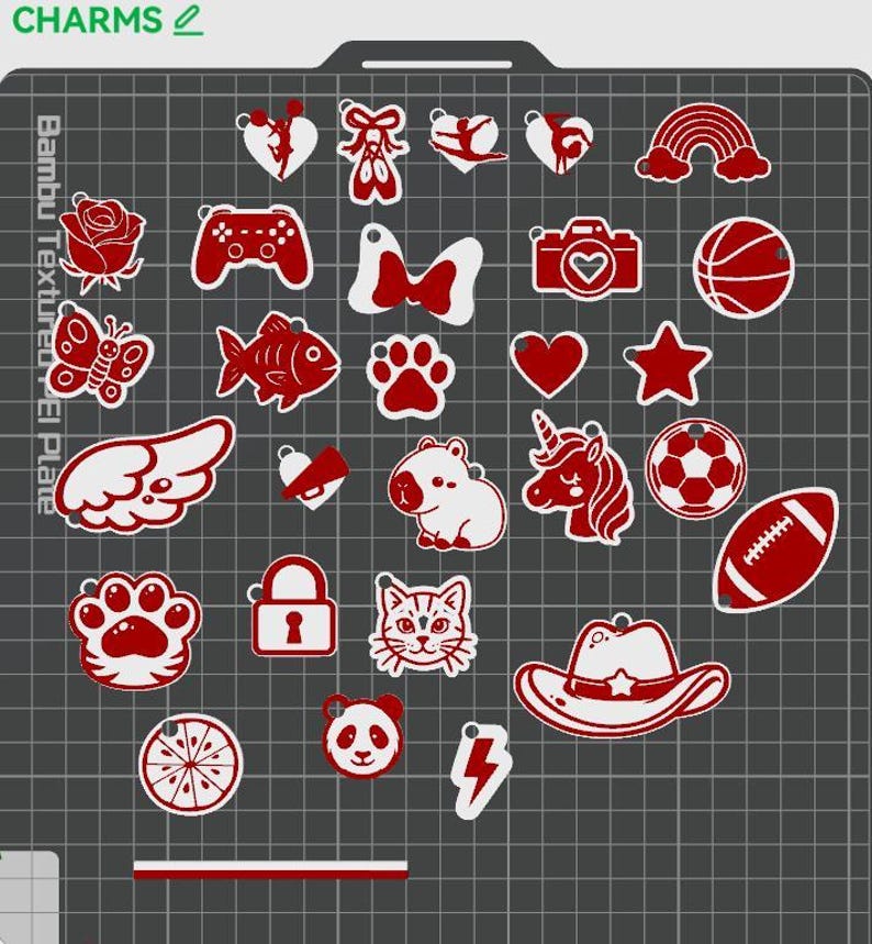 Selection of cute red and white acrylic-style charm add-ons for personalized keychains, displayed on a grid background. Charm options include fairy silhouette, bows, rainbow, rose, butterfly, gaming controller, camera, basketball, fish, paw prints, hearts, stars, wing, bell, hippo, unicorn, soccer ball, football, cat face, tiger paw, cowboy hat, panda, lightning bolt, orange slice, and lock charm. Kawaii cartoon style charms for custom sports, animal, gaming, and aesthetic keychains.