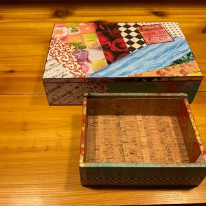 May include: A colorful wooden box with a drawer. The box is decorated with a collage of paper scraps, including a vintage ticket for "Shaw's Circus". The drawer is lined with cork.