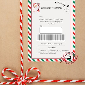 Puede incluir: Un paquete de papel con rayas rojas y verdes con una etiqueta blanca que dice "LIEFERUNG VOM NORDPOL" y tiene un sello de Santa Claus. La etiqueta también incluye una dirección de entrega para la oficina de correos principal de Santa Claus en Napapiiri, Finlandia. El paquete está atado con una cinta de rayas rojas y blancas.