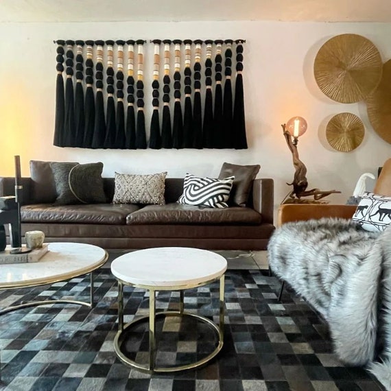 At $1,950 with 21 favorites, this large-format noir macrame is clearly a statement art piece — the dark colorway alone makes it a rare departure from the beige-boho sea.