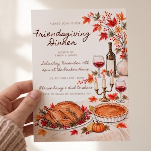 May include: A Friendsgiving dinner invitation card featuring watercolour illustrations of a roasted turkey, a pie, wine glasses, a bottle, and autumn leaves. The text reads: Please join us for Friendsgiving Dinner, hosted by Emma + James, Saturday, November 14th, 5pm at the Parker Home, 125 Autumn Lane, Boise. Please bring a dish to share, RSVP to Emma by November 7th.