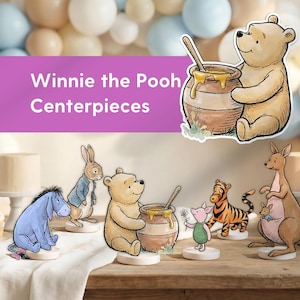 May include: Winnie the Pooh themed centrepieces featuring Pooh Bear with honey, Eeyore, Rabbit, Piglet, Tigger, and Kanga with Roo. The characters are on white bases, with a purple banner that reads "Winnie the Pooh Centerpieces".
