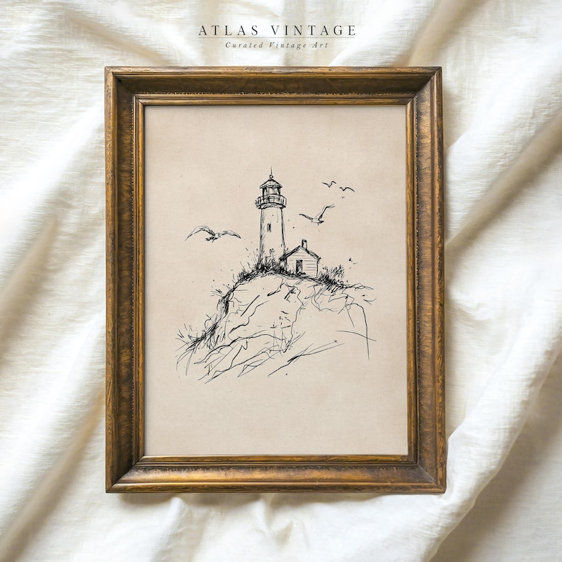 May include: Framed vintage art print featuring a lighthouse on a rocky cliff, with seagulls in flight. The artwork is a black and white sketch, set against a neutral background, and framed in a gold-toned wooden frame. The text "ATLAS VINTAGE Curated Vintage Art" is at the top.