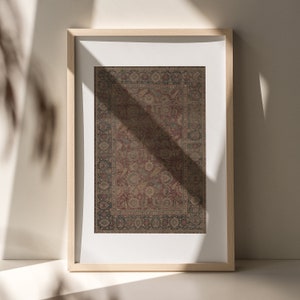 May include: A framed print of a vintage rug with a detailed floral pattern in shades of red, brown, and blue.