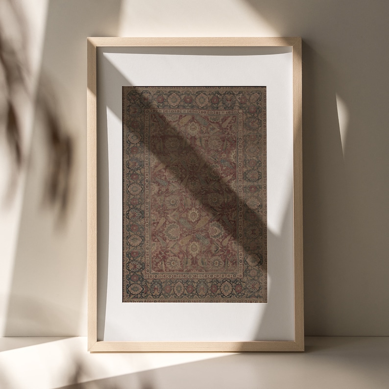 May include: A framed print of a vintage rug with a detailed floral pattern in shades of red, brown, and blue.