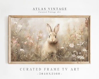 Puede incluir: Una pintura vintage de un conejo blanco en un campo de flores. El conejo está mirando directamente al espectador. La pintura está enmarcada en un marco de madera claro. El texto "CURATED FRAME TV ART - 3840X2160 -" está debajo de la pintura.