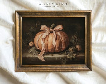 May include: Framed vintage art print featuring a still life of a pumpkin with a pink ribbon. The pumpkin is a warm orange color, set against a dark background with foliage. The frame is a gold color, and the text "ATLAS VINTAGE Curated Vintage Art" is at the top.