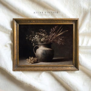 May include: A framed vintage still life painting. It depicts a dark vase filled with dried flowers and grasses. The artwork has a muted colour palette and a gold-toned frame. The text "ATLAS VINTAGE Curated Vintage Art" is at the top.