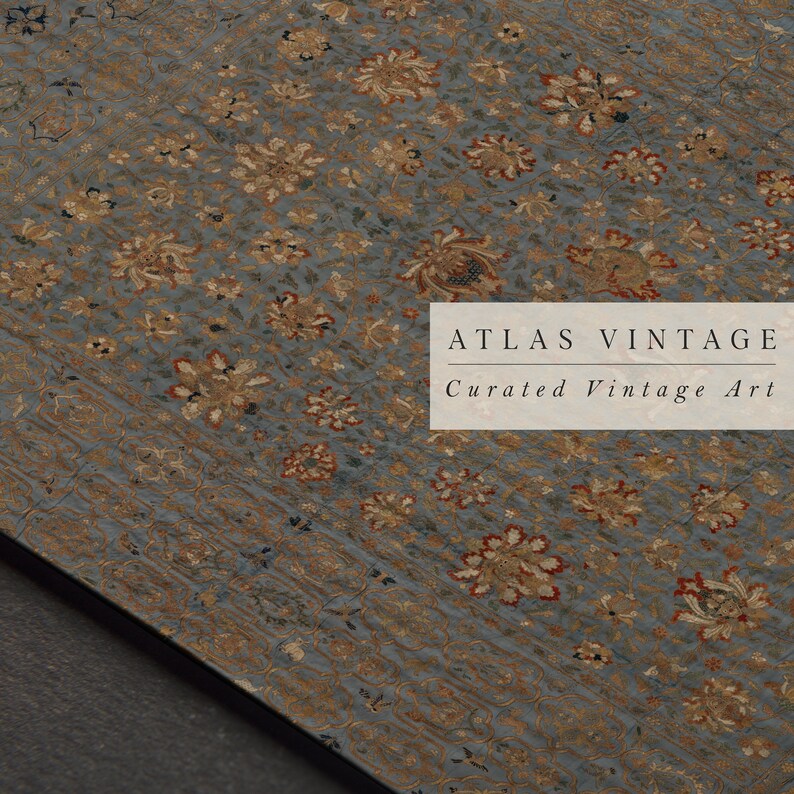 May include: A close-up of a vintage rug with a floral pattern in shades of gold, red, and blue. The rug has a textured surface and is made of a fine material. The text "ATLAS VINTAGE Curated Vintage Art" is printed on the rug.