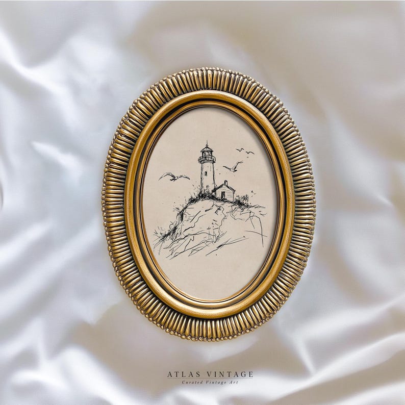 May include: Oval gold-toned frame with a sketch of a lighthouse on a cliff, with seagulls in flight. The artwork is in black and white. The frame has a textured, ridged border. The text "ATLAS VINTAGE" is at the bottom.