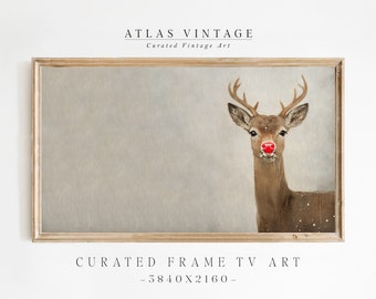 May include: A framed print of a reindeer with a red nose against a light gray background. The frame is a light wood color. The text "ATLAS VINTAGE" and "Curated Vintage Art" is at the top of the image. The text "CURATED FRAME TV ART - 3840x2160 -" is at the bottom of the image.
