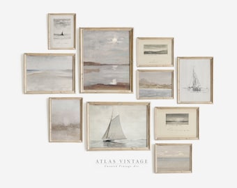 May include: A collection of framed vintage art prints featuring coastal and seascape scenes. The artwork includes sailboats, serene landscapes, and atmospheric skies in muted tones of gray, beige, and brown. The frames are a warm gold color. The text "ATLAS VINTAGE Curated Vintage Art" is visible.