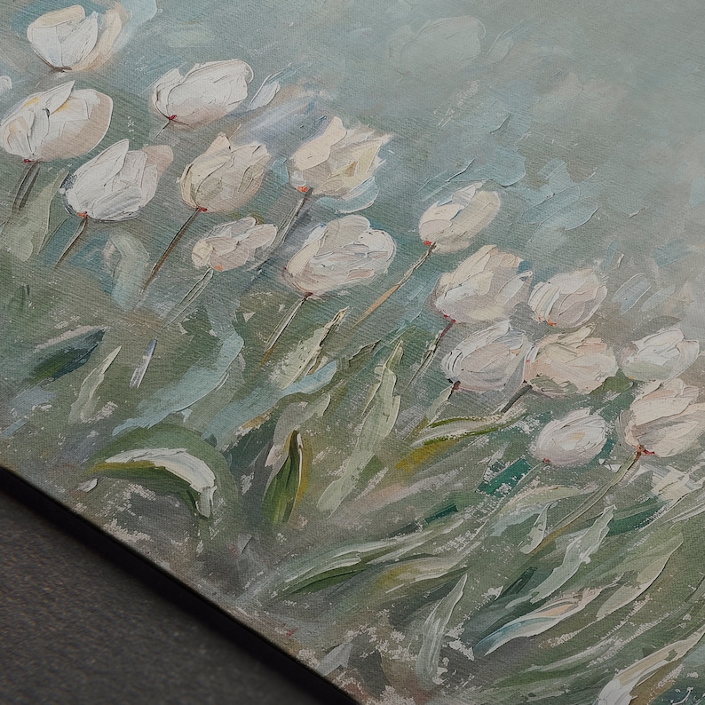 May include: Oil painting depicting white tulips in a field. The flowers are in full bloom with textured brushstrokes, set against a soft, light blue and green background. The artwork is on a canvas.