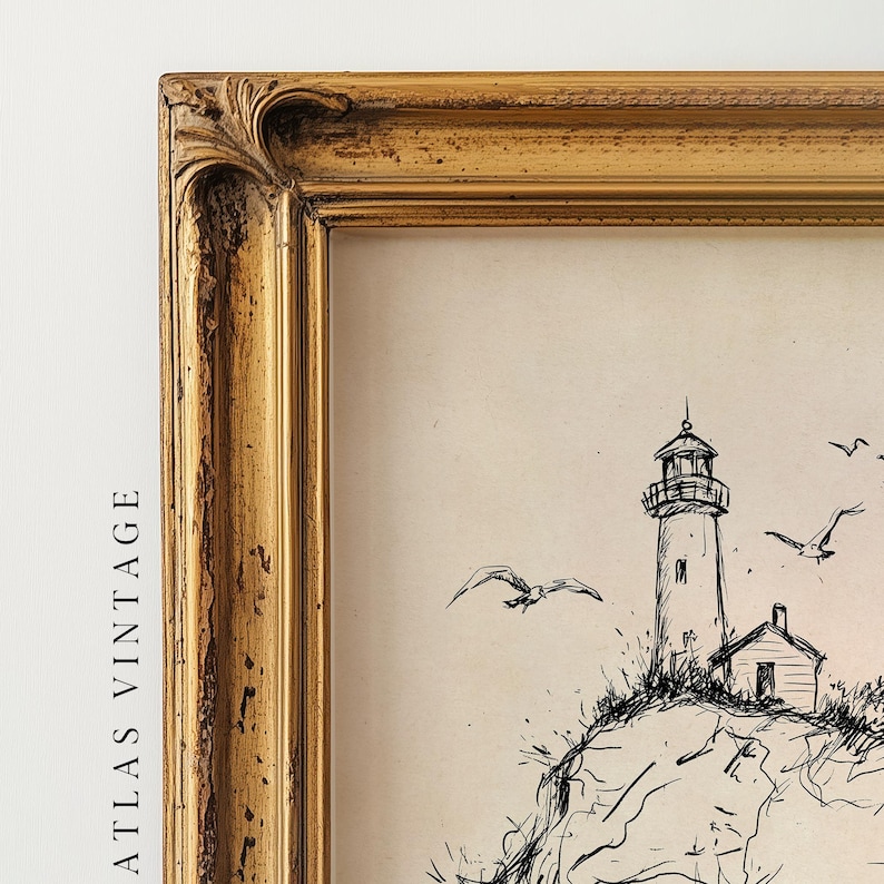 May include: A framed vintage print featuring a black and white sketch of a lighthouse on a rocky cliff, with seagulls in flight. The frame is a distressed gold color, adding to the antique aesthetic. The text "ATLAS VINTAGE" is visible on the left side.
