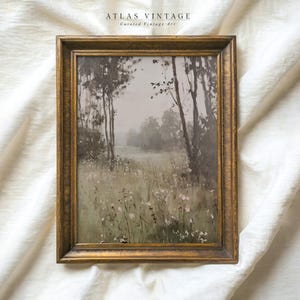 May include: A framed painting depicting a misty forest scene with a field of wildflowers in the foreground. The painting is in a gold frame and has a vintage feel.