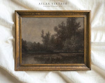 May include: A framed landscape painting depicting a misty forest scene with a river in the foreground. The painting is in a gold frame and has a muted color palette.
