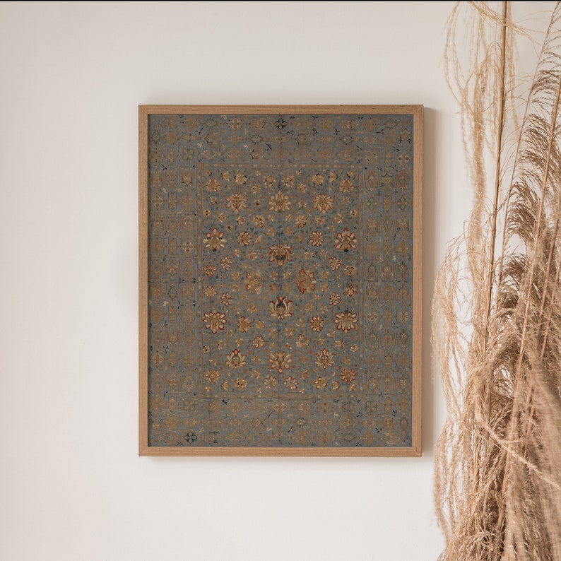 May include: A framed print of a vintage rug with a blue background and intricate floral patterns in shades of gold, red, and white.