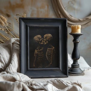 Gothic skeleton couple kissing in a dark, romantic scene.