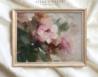 May include: A framed floral oil painting featuring pink roses and green leaves. The artwork is set against a neutral background and framed in a light-colored wooden frame. The text "ATLAS VINTAGE Curated Vintage Art" is at the top.