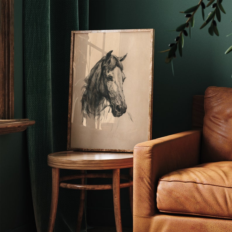 May include: A black and white drawing of a horse's head in a brown wooden frame. The drawing is on a beige background. The frame is hanging on a wall.