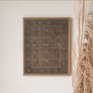 May include: A framed print of a vintage rug with a detailed floral pattern in shades of red, brown, and beige. The rug is surrounded by a dark wood frame.