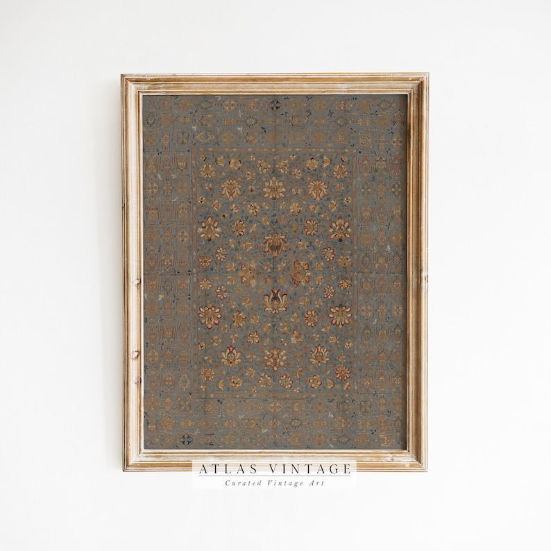 May include: A framed print of a vintage rug with a floral pattern in shades of blue, gold, and red. The frame is a light wood color. The print has the text "ATLAS VINTAGE Curated Vintage Art" at the bottom.