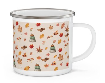 May include: White enamel mug with a pattern of fall leaves, pumpkins, and cinnamon sticks on a beige background.